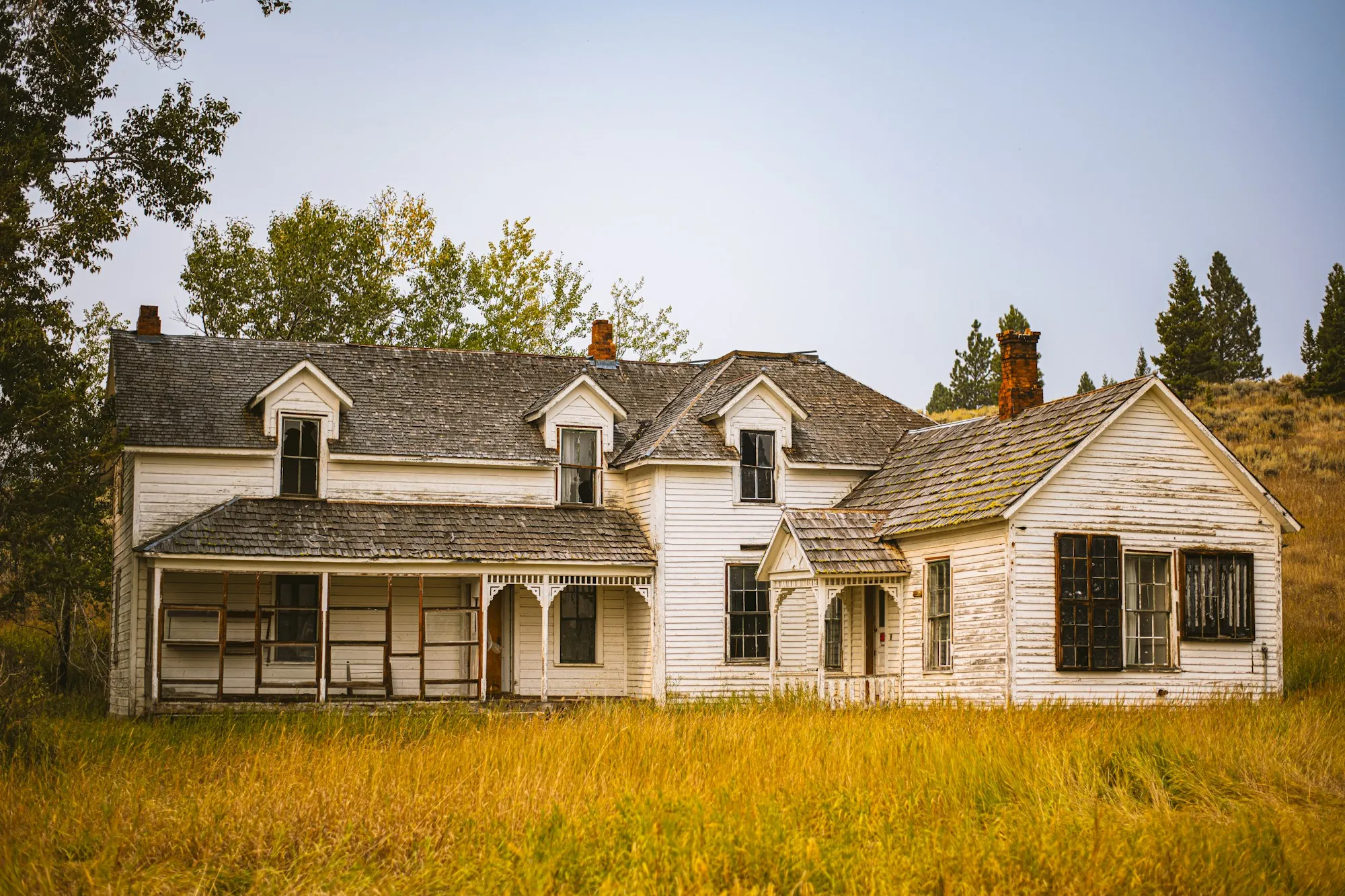 Older two-story house in a field